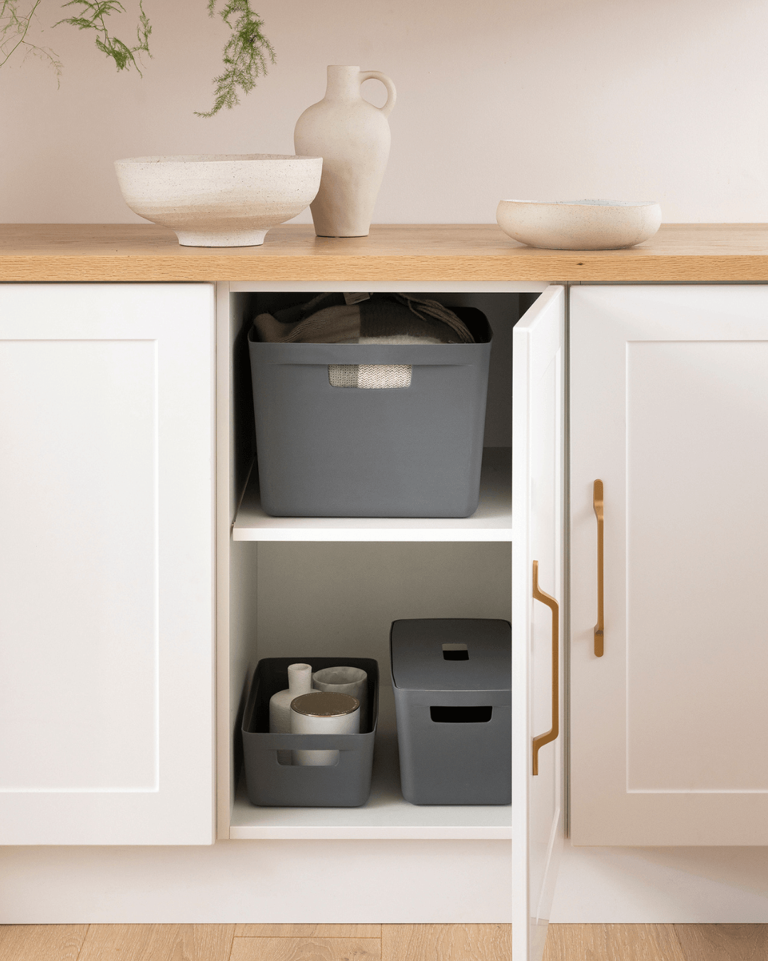 Organise & Clean with Inabox Is getting the house organised one of your New Year’s resolutions? There’s no time like the present to reset and give your home a deep clean! It might seem like a mammoth task, so we’d recommend completing one room per week. Here are some tips for getting started on those key areas: Discard old cleaning products Completing a stocktake of your household cleaning products is an often-overlooked part of the whole process. These can accumulate over years, so it’ is important make sure you’re still using products that work, while decluttering at the same time. Check the use by dates and discard any cleaning agents that have expired. Store all remaining cleaning products in our handy Modular Containers. Coming in a variety of stackable and functional sizes, this storage solution will compliment any style of room with sleek, neutral tones. Avoid contamination and minimise waste by assigning washable, colour-coded microfibre cloths to each room, like pink for the kitchen and green for the bathroom. . Kitchen Store your sprays, detergents and oven cleaners in a Modular Container under the sink. Pair with a pink microfibre cloth for tackling greasy kitchen areas. Go through your fridge, freezer and pantry, discarding any unwanted goods. Take out all other items shelf by shelf and wipe everything thoroughly. Distribute your significant kitchen items, such as condiments, cling wraps/foils and perishable objects into a series of Modular Containers. Clean the inside and outside of your microwave and oven. Spray and wipe your benches, cabinets, stove top and splashbacks. Bathroom Start by removing the contents of all drawers and cupboards, discarding any empty bottles or trash. Wipe out and rearrange your bathroom essentials. Our Insert Trays can help with dividing your items into smaller compartments, to neatly store things like toothbrushes, skincare, razors and makeup. Take everything out of the shower and use a cleaning agent to scrub the floors, walls and glass. Don’t forget to remove the cover of your ceiling fan and give it a soak. This will get rid of excess dust and prevent mould from forming. Shine up the bathroom mirror with a dry paper towel and glass cleaner. Sweep and mop the floors. Finally, give your toilet a deep clean by soaking the inside with bleach and using a surface cleaner to wipe down the external surface. Laundry Using one of our stylish Modular Containers, store your laundry detergent, fabric softeners and a yellow microfibre cloth, neatly keeping everything in one place. This can be displayed out on the laundry bench or stored away in a cupboard. Spray and wipe down your benches and the exterior of your washer and dryer. Remove the filters and soak in warm, soapy water for 10 minutes. Laundries are great storage rooms for spare linens and towels. Remove existing items from the cupboards so you can spray and wipe the shelves, then reorganise the contents, repacking everything into Modular Containers, so that your linen and towels are organised and protected from dust Outdoor and Pool When sprucing up outdoor areas, larger tools such as pressure hoses, mulch and buckets are required. The ideal location for storing these bulky items is in an outdoor shed or garage. This being the case, you want a sturdy storage solution to keep your items safe from the elements. Our Heavy Duty Containers range from 27L to 100L, designed with durability in mind, they come in a variety of shapes and sizes, as well as a padlock socket for added security. For your smaller items, such as seeds, nails and tools, the Heavy Duty Insert Tray is perfect. Whereas our Heavy Duty Dividers allows for easy separation of contents, providing quick and easy access to your belongings. Voila! Your home will be looking spick and span with the help of Inabox storage solutions and ready to take on the New Year!. For more storage tips, tricks and ideas, visit our blog or follow us on Instagram, Facebook and Pinterest. 